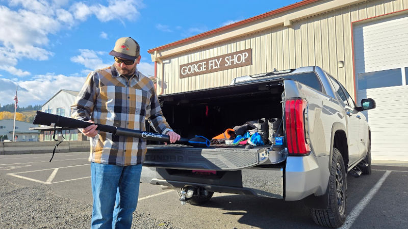 Charlie inspecting a Scott Fly Rod Gorge Fly Shop Rods