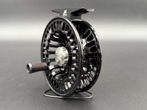 Abel TR fly reel in Black finish with ported spool and palming rim